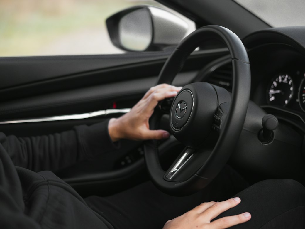 Driver with hands on the steering wheel