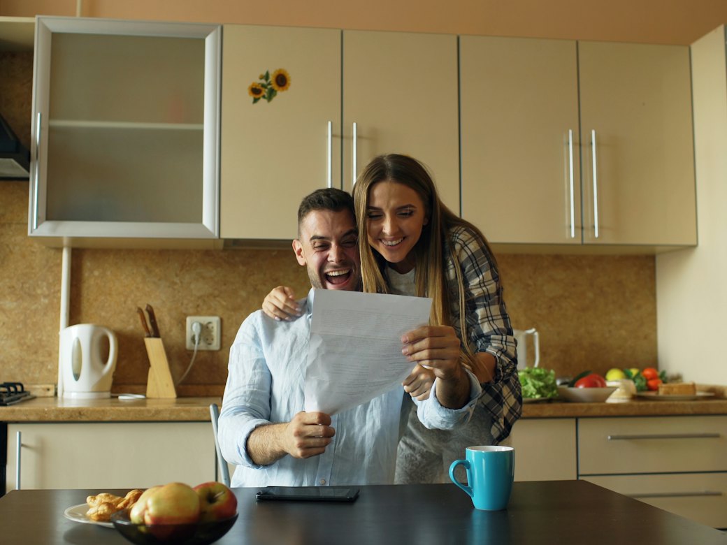 Couple reviewing a document together at home